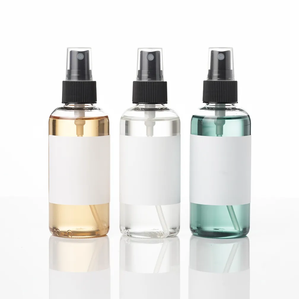 Three spray bottles — amber, clear, teal — with blank labels, generated by flux-2