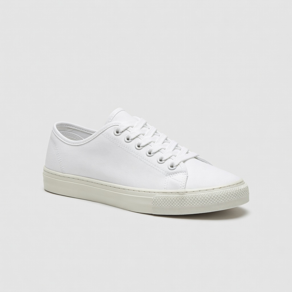 Input: white low-top canvas sneaker product photo on a light gray studio background