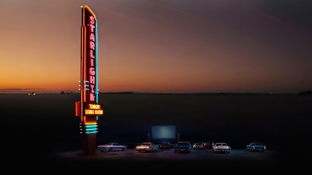 A retro 1970s American drive-in movie theater at dusk with a glowing neon marquee reading STARLIGHT DRIVE-IN and TONIGHT: DOUBLE FEATURE