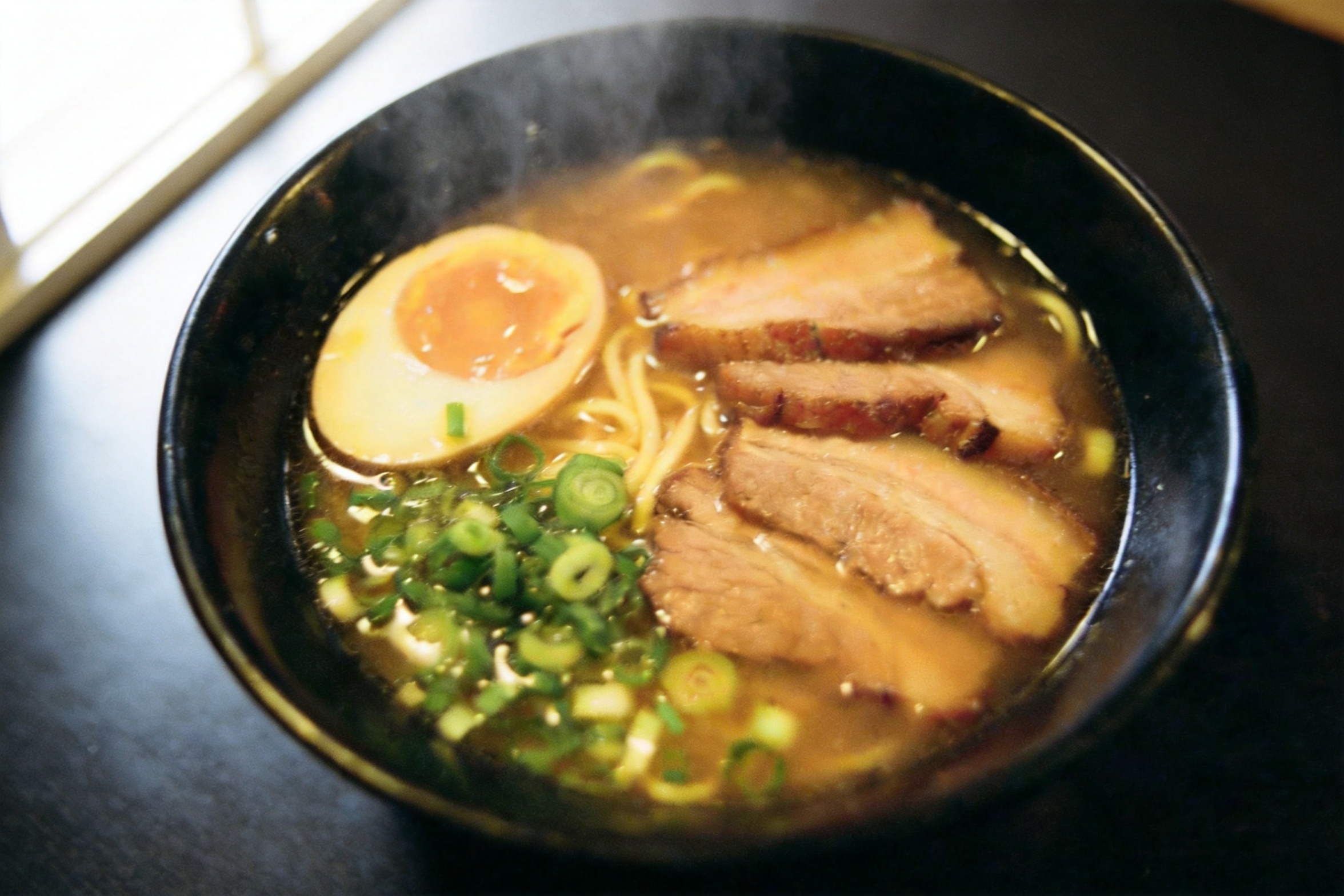 Output: same ramen bowl relit as a bright editorial photo with steam