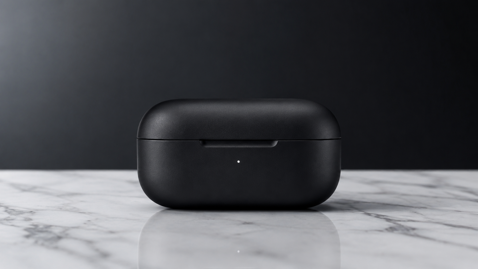 Input frame: closed matte black earbuds case on marble