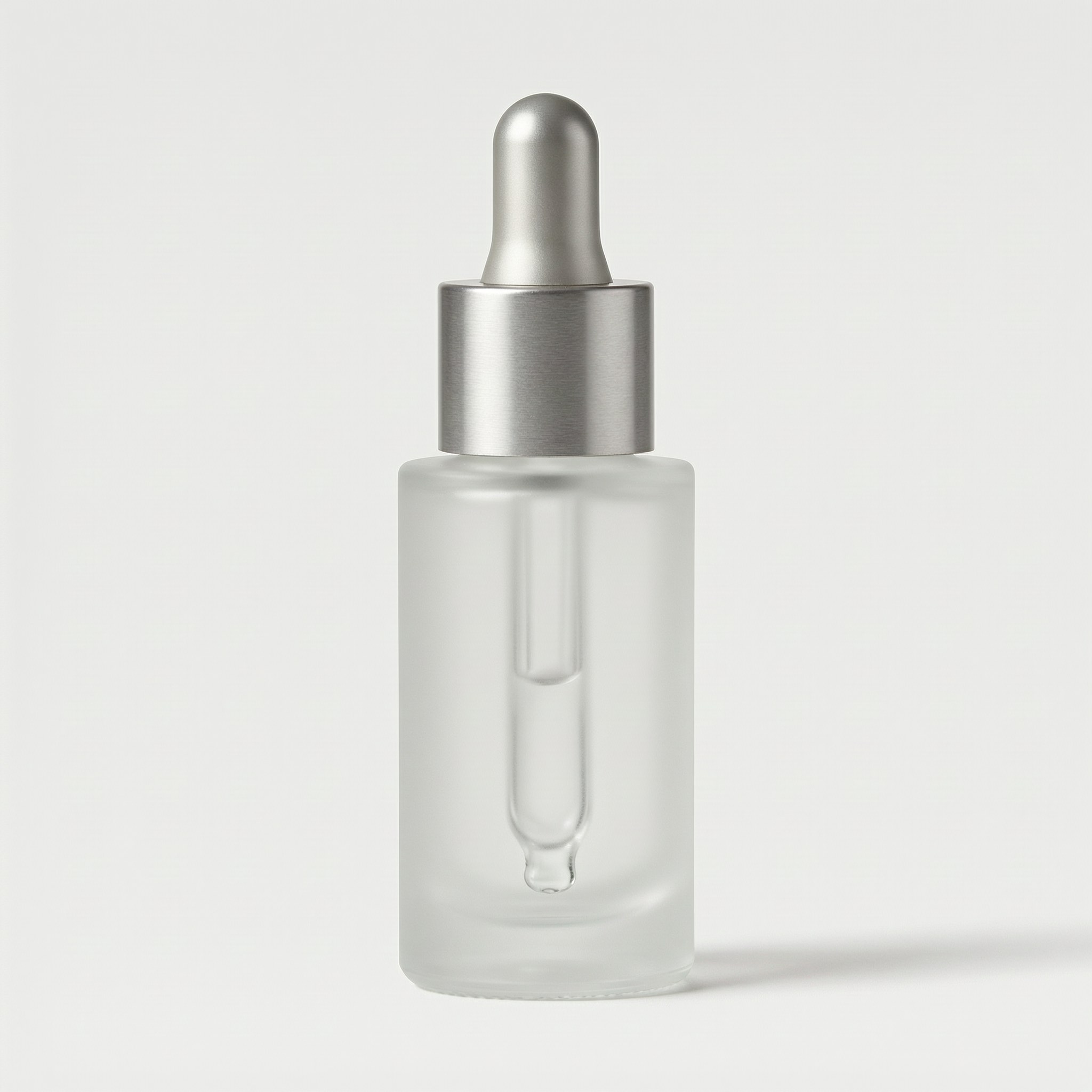 Frosted glass serum bottle on a pure white background with a soft contact shadow