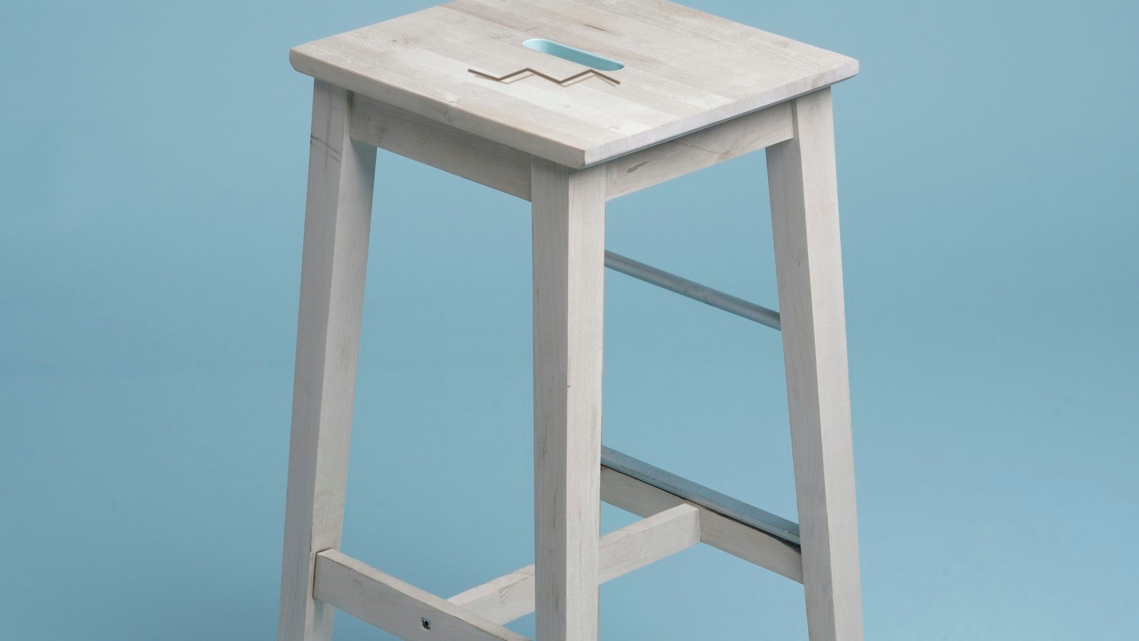 Source: a pale oak stool with a dark zigzag scratch across the seat